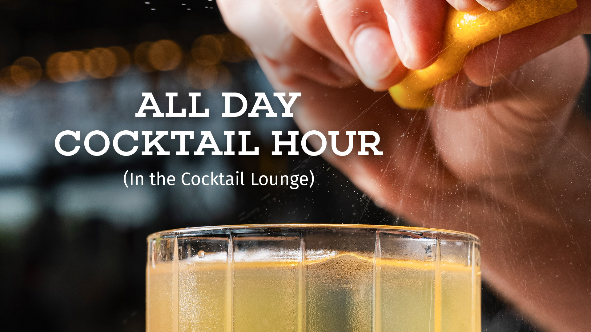 Bartender squeezing orange peel juices onto a freshly poured cocktail